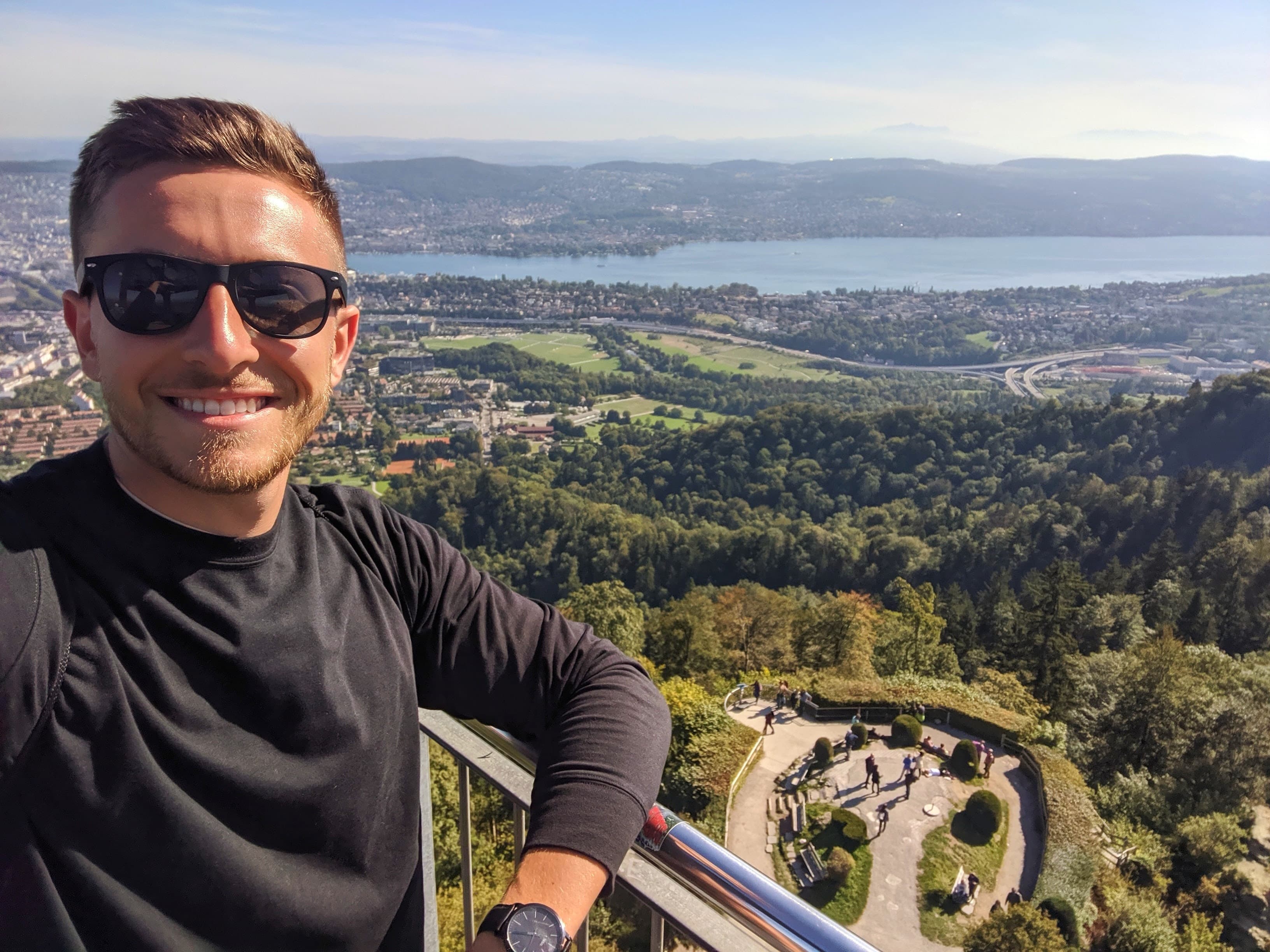 Chris Ray at a viewpoint overlooking a city and lake